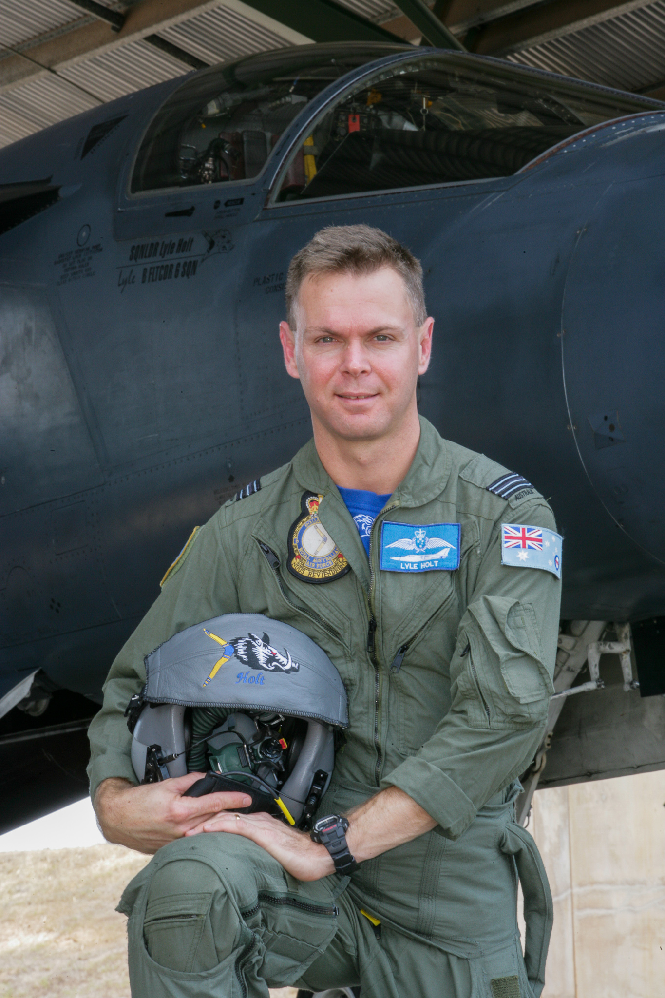 Squadron Leader Lyle Holt beside the F-111 at RAAF Base Amberley, name and B Flight Commander 6 Squadron markings visible on the fuselage