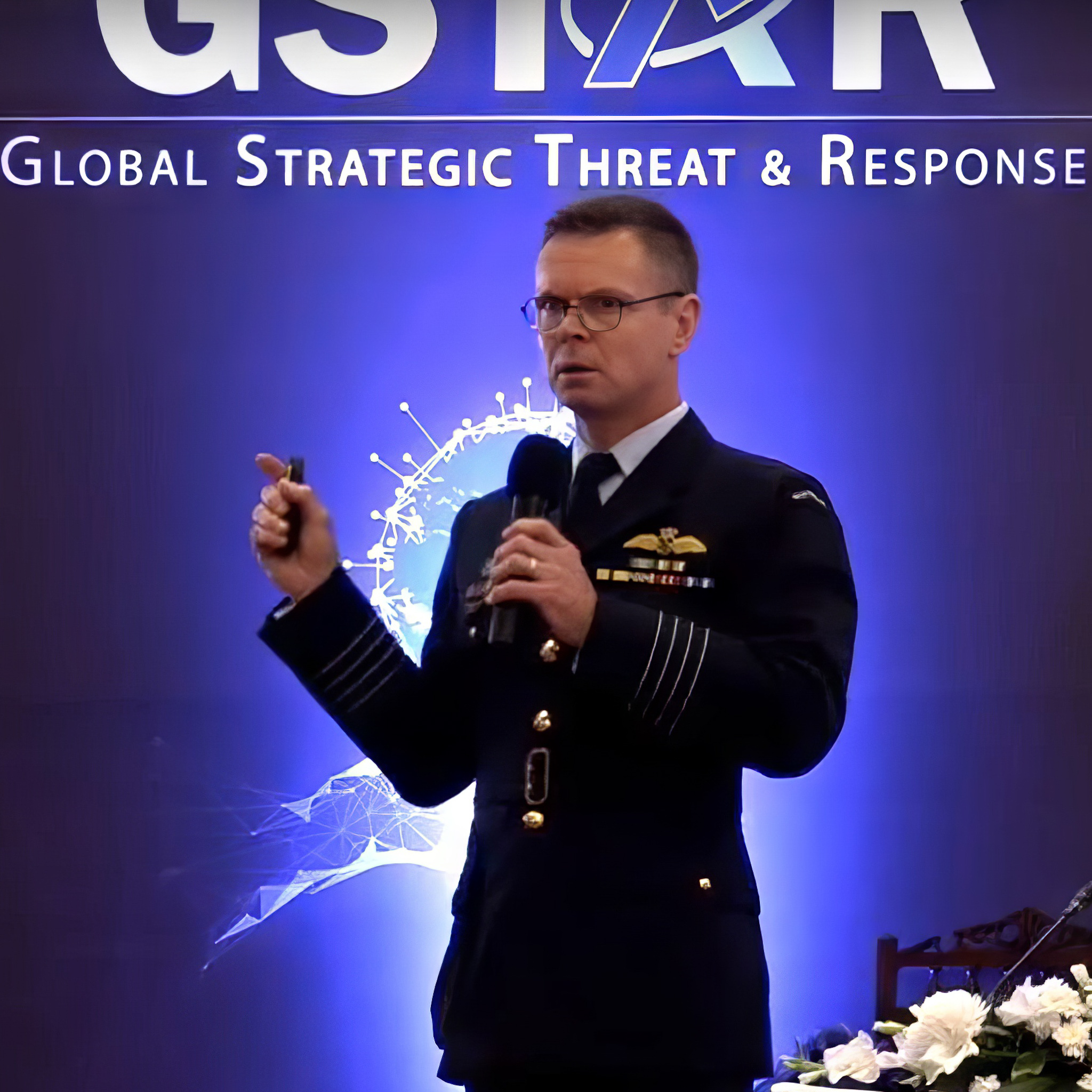 Lyle Holt presenting at GSTAR 2020 — Global Strategic Threat and Response international conference, RAAF Group Captain in mess dress