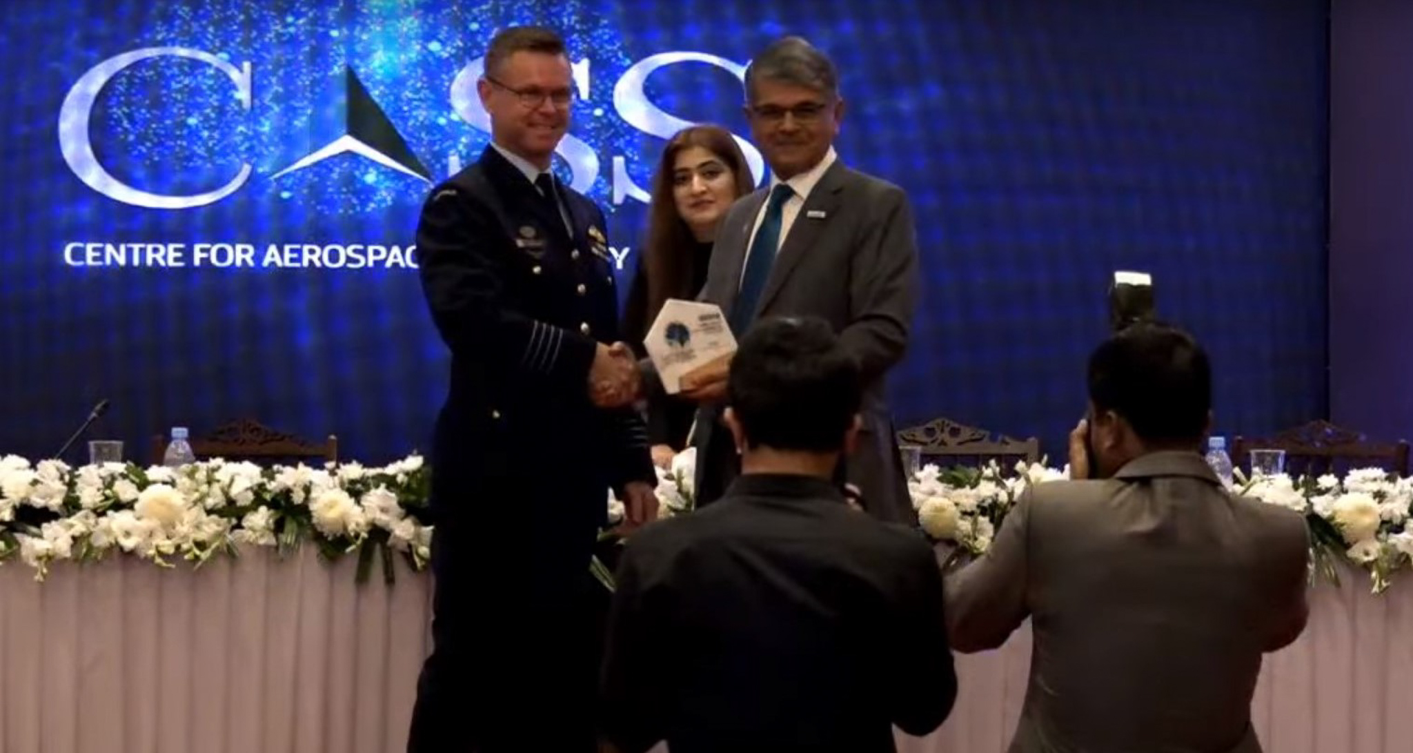 Lyle Holt receiving a commemorative shield from the Centre for Aerospace and Security Studies at the GSTAR 2020 international conference — RAAF officer recognised as an invited international speaker