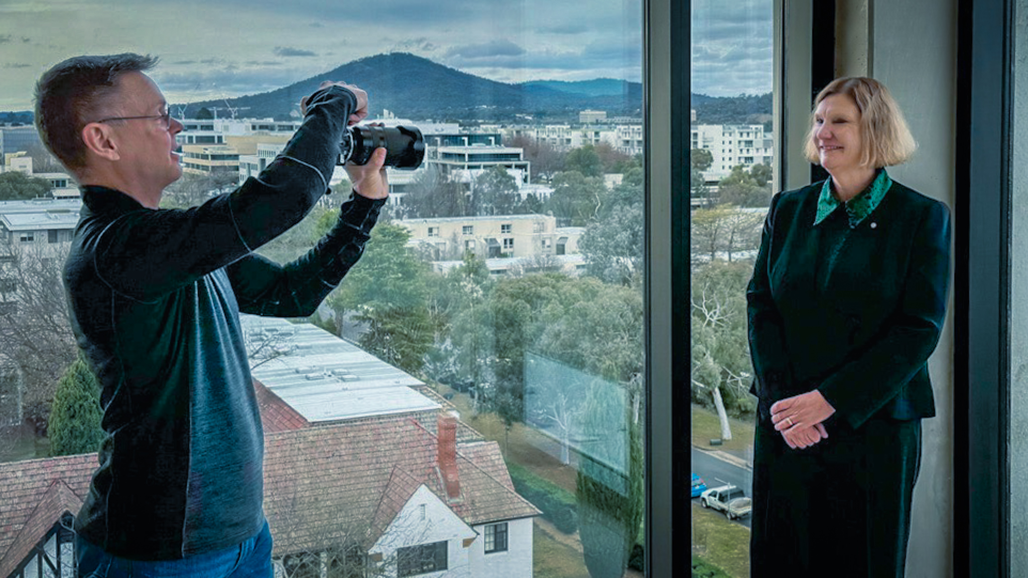 Lyle Holt directing an institutional authority portrait session for Air Vice-Marshal (Ret'd) Catherine Roberts AO, CSC — a portrait subsequently deployed by ASX-listed Electro Optic Systems for board-level governance communications