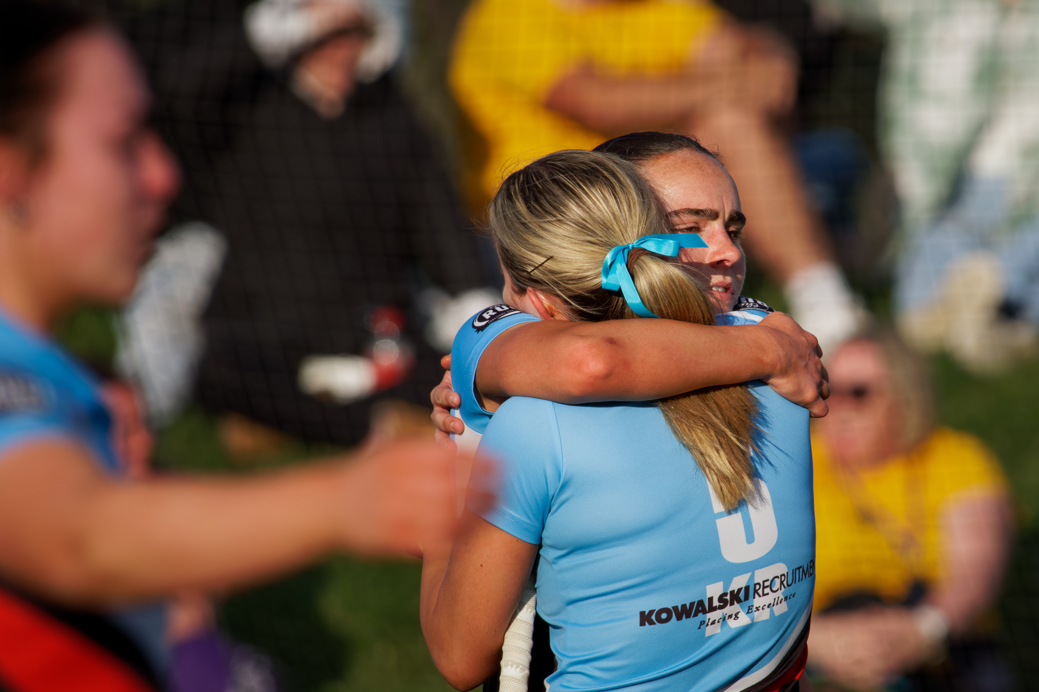 Hockey ACT senior women's grand final, losing side players console each other