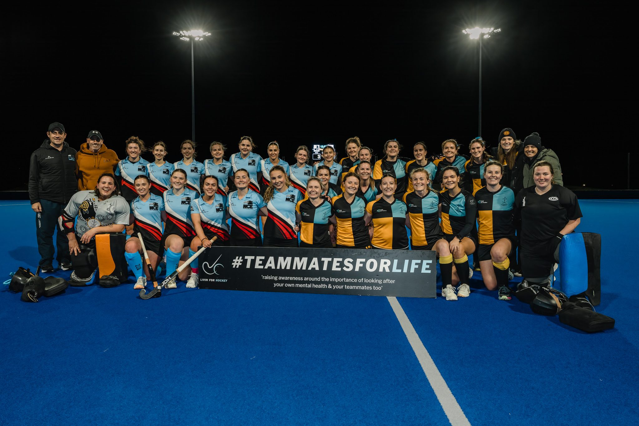 Livin for Hockey campaign, full team with Teammates for Life sign