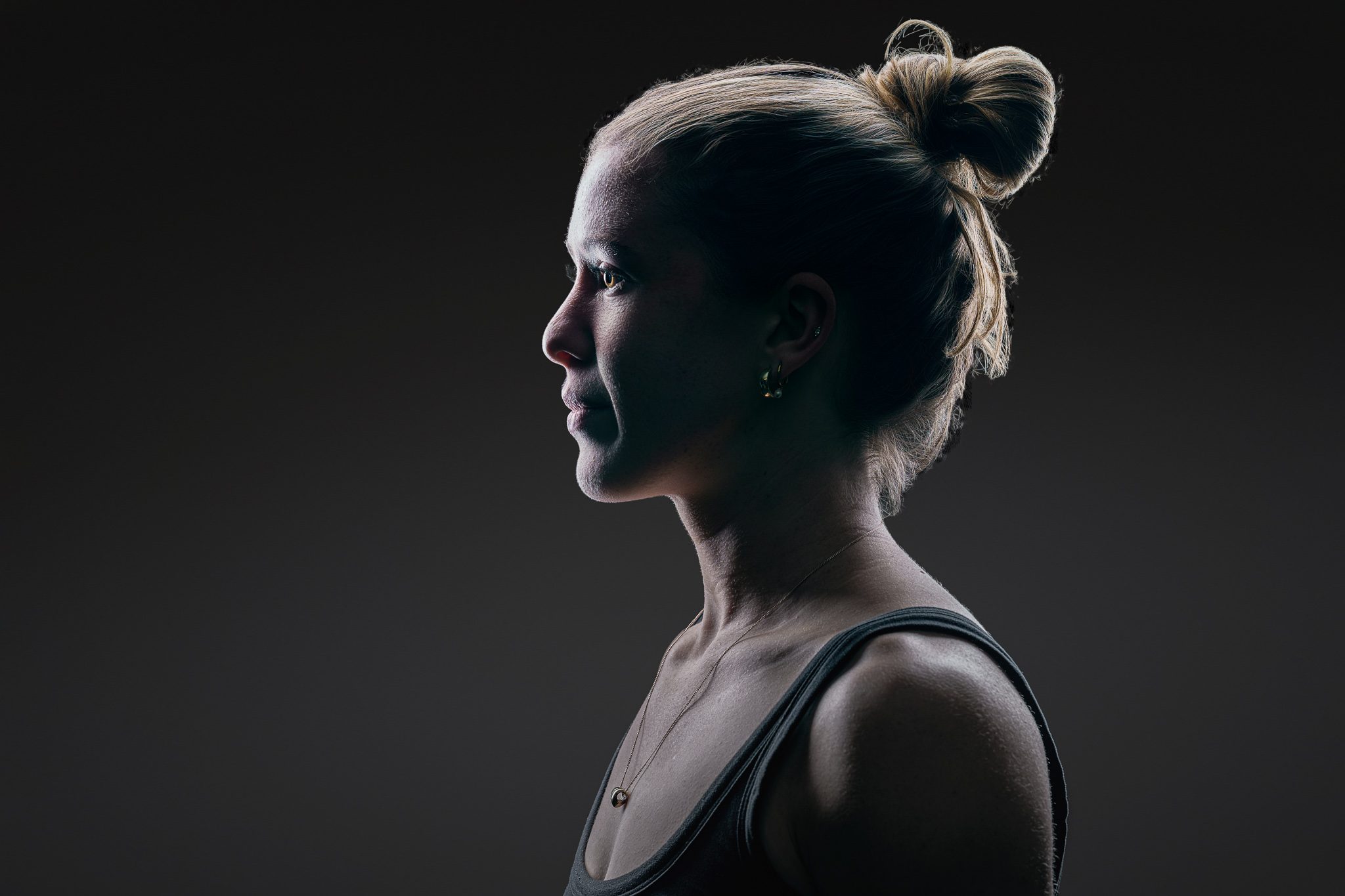 Lucy athlete identity profile portrait, high-contrast backlit
