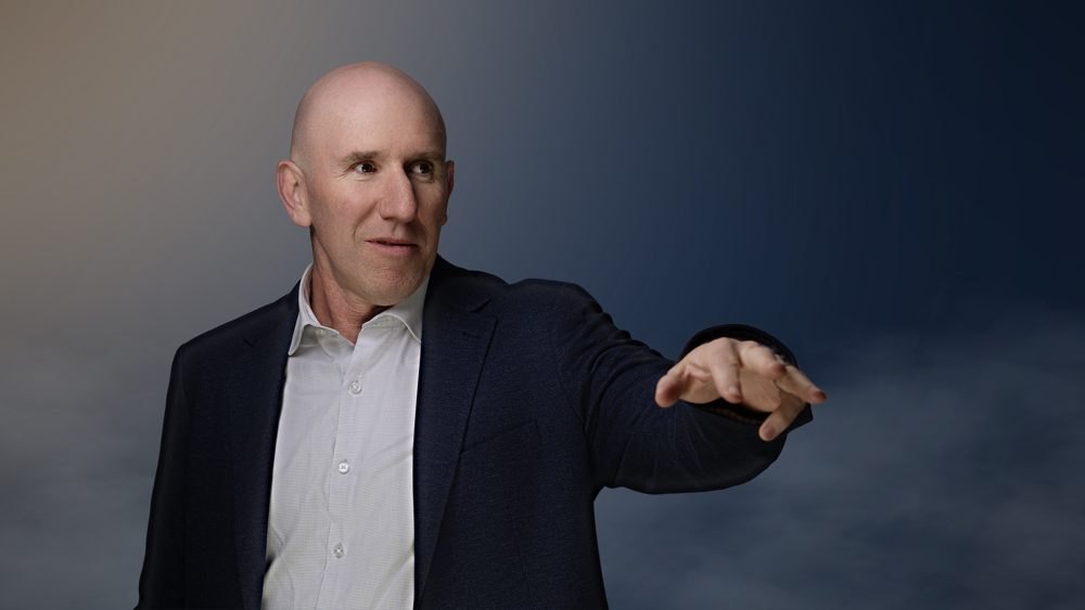 Dr Anthony Walker, one of four directed speaking gestures on a stage setting in OHP colours