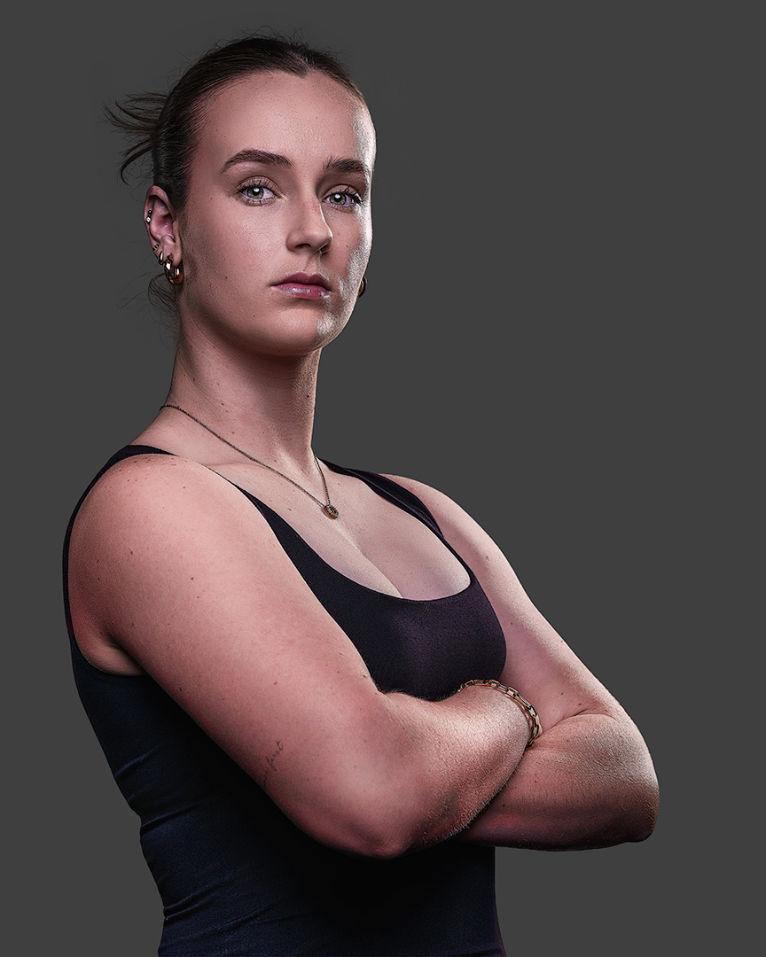 Marcelle — elite athlete identity portrait, arms crossed, authoritative stance