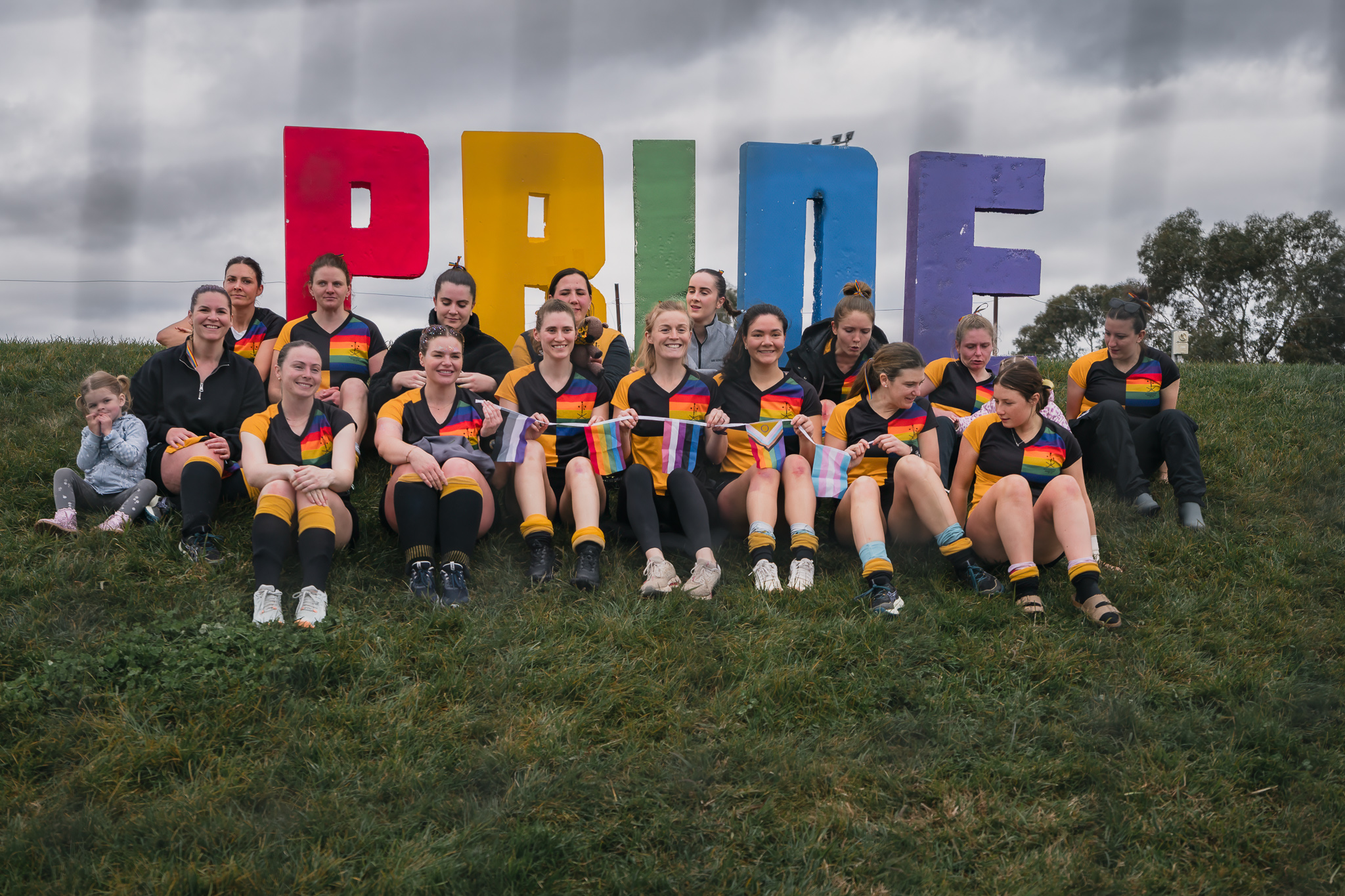 Hockey ACT Pride Round — full team with trans and rainbow flags, community representation