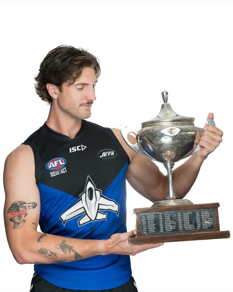 AFL Canberra Media Day portrait, player holding the premiership cup