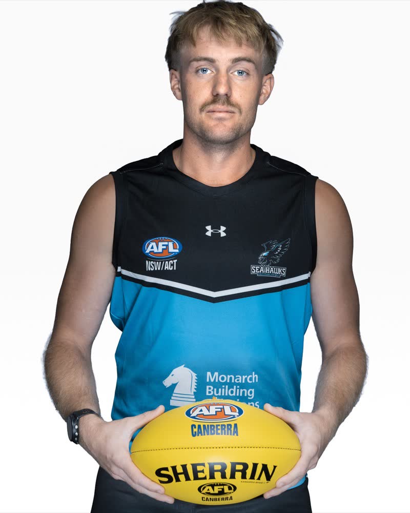 AFL Canberra Media Day studio portrait, arms crossed