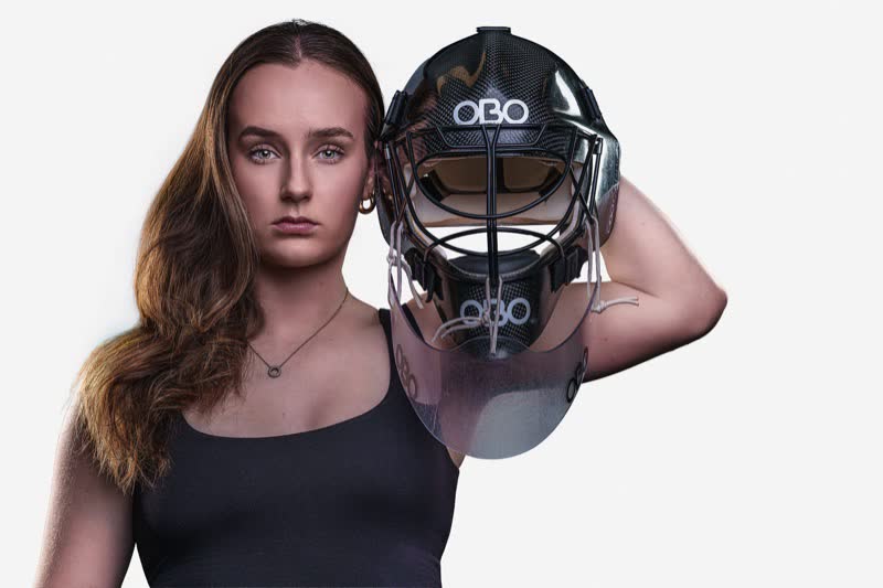 Hockey ACT goalkeeper identity portrait in helmet, high-key white background
