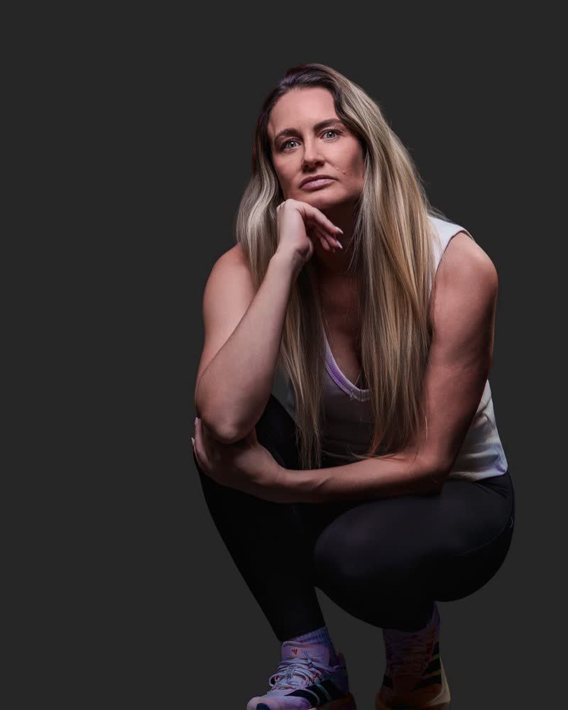 Hockey ACT pathway athlete in a low ready position, studio identity portrait on black