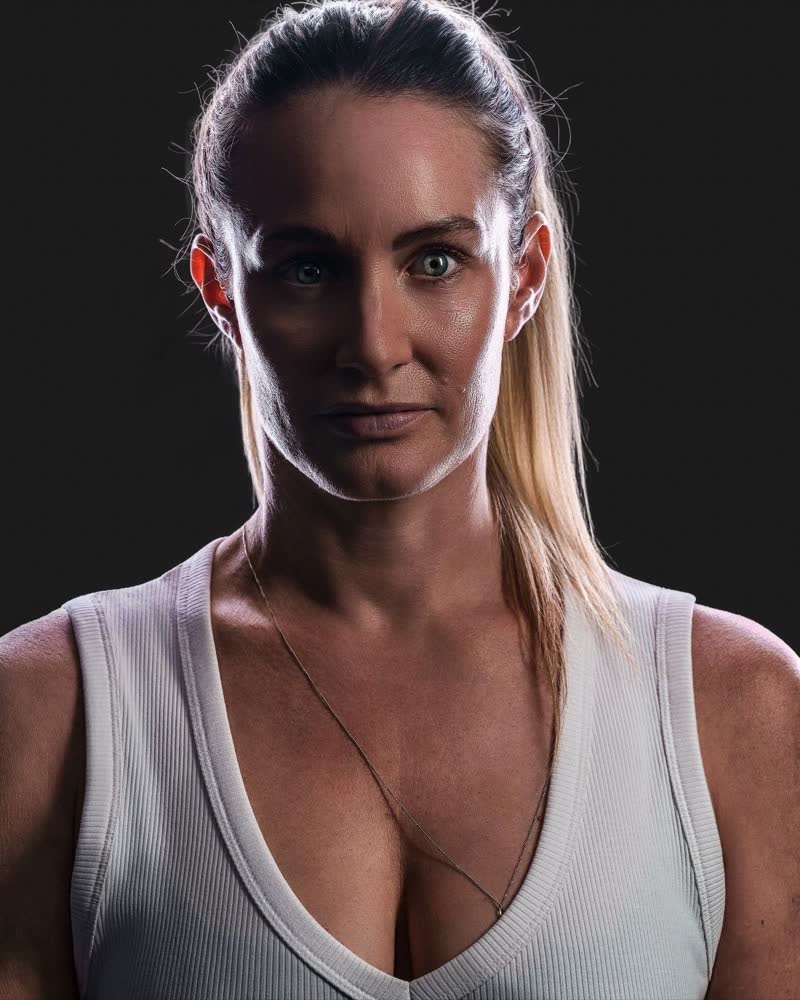 Hockey ACT pathway athlete identity portrait, front-on under dramatic single-source rim lighting
