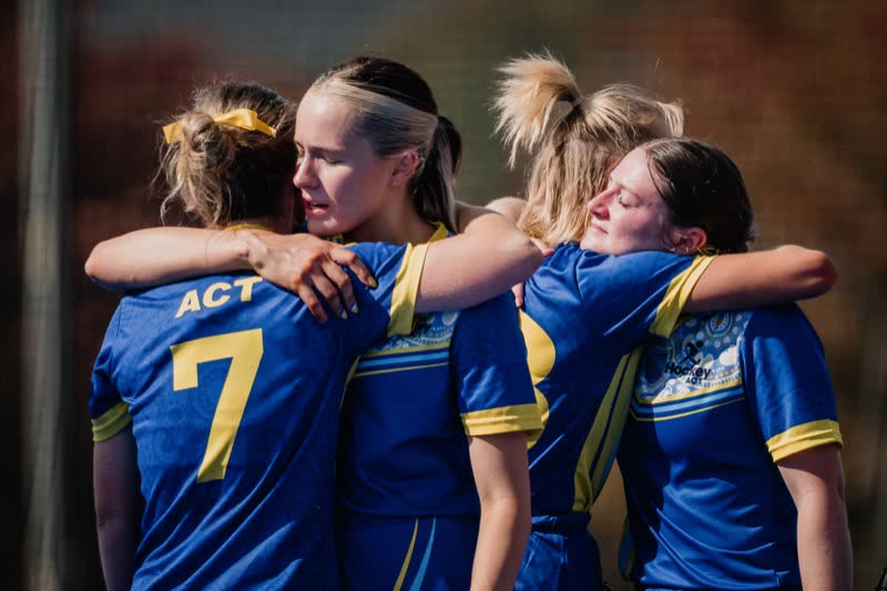 ACT players embrace after a match