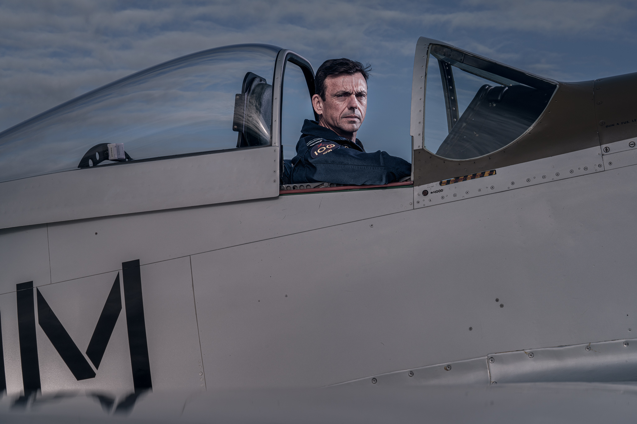 FLTLT Chris Tulk — cockpit portrait, stormy sky, looking left
